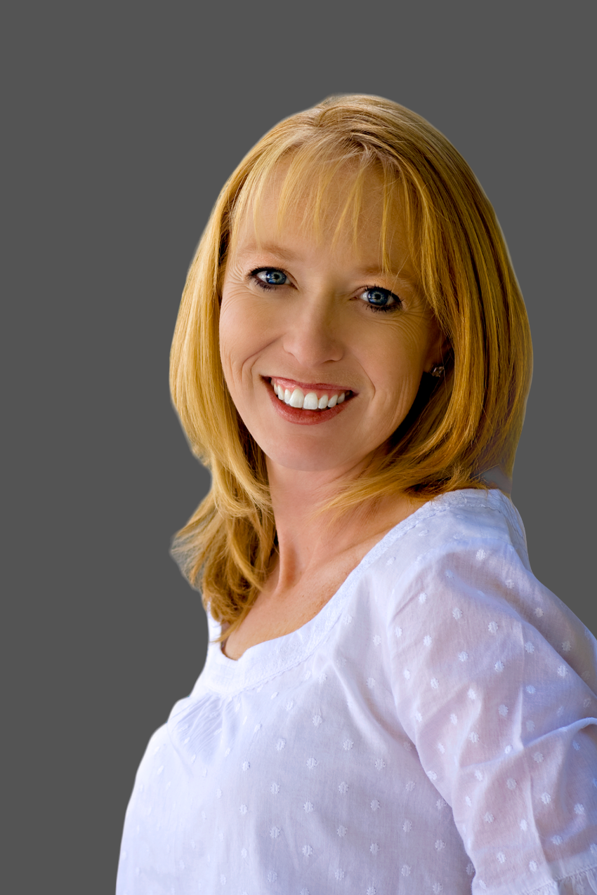 Carey Light smiling in a professional headshot on a dark grey background
