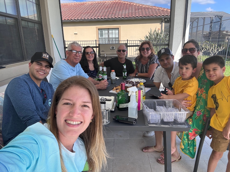 Fabiola Meneses Smiling with family gathered around a table