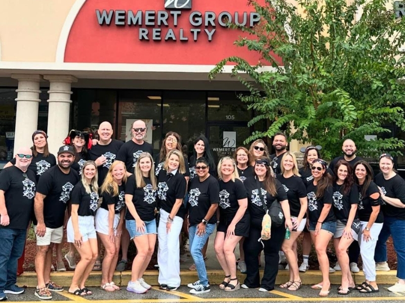 Lauren Miller with Wemert Group Realty Team in Front of Office