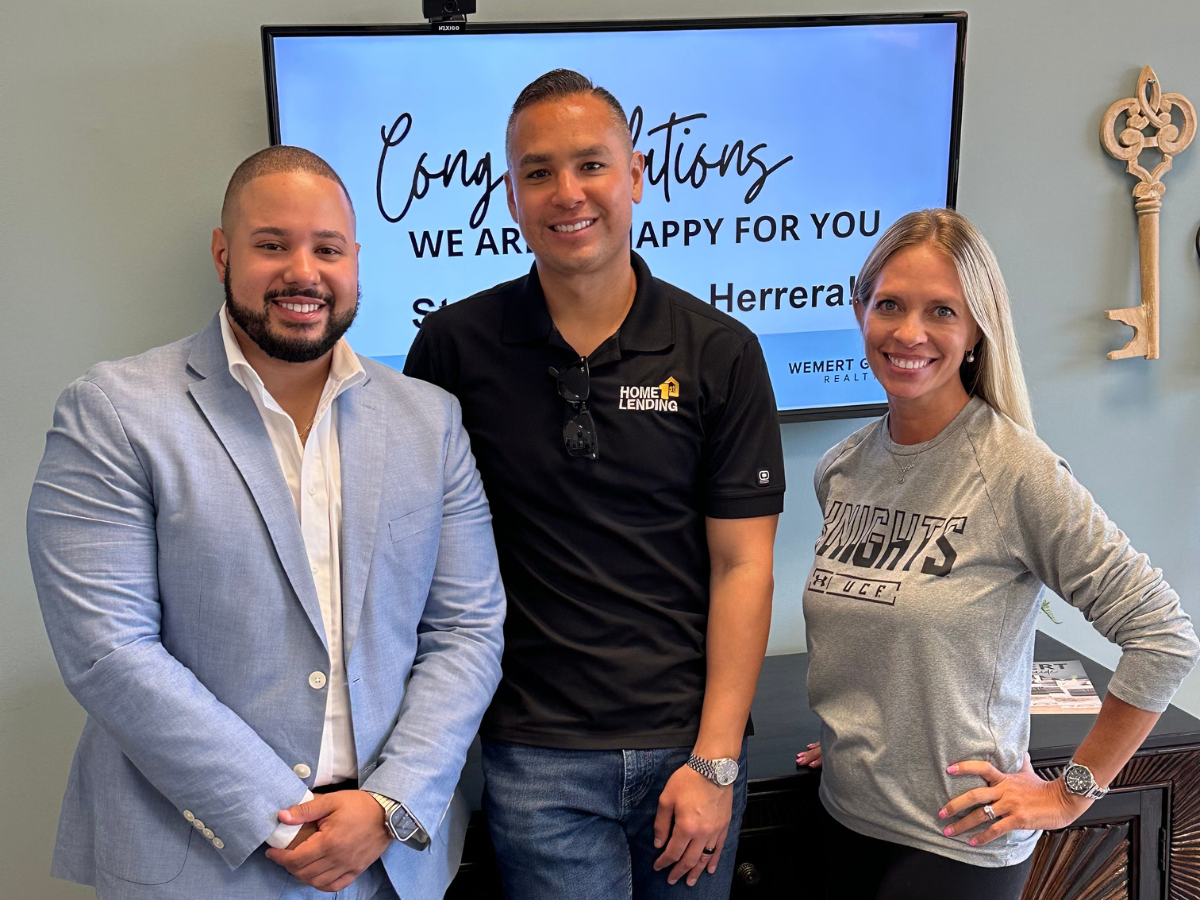alvin abud with lender partner and client at closing at wemert group realty