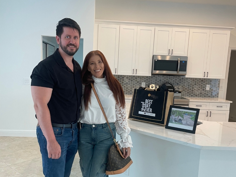Staci Kowalczyk's clients smiling at closing with a closing bag on the counter